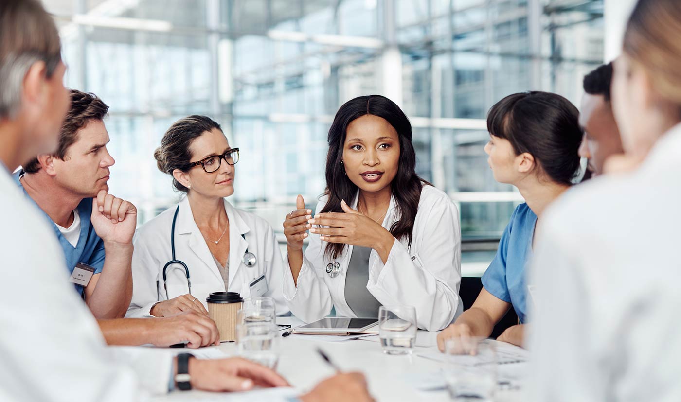 Medical staff in a meeting discussing operational efficiency.