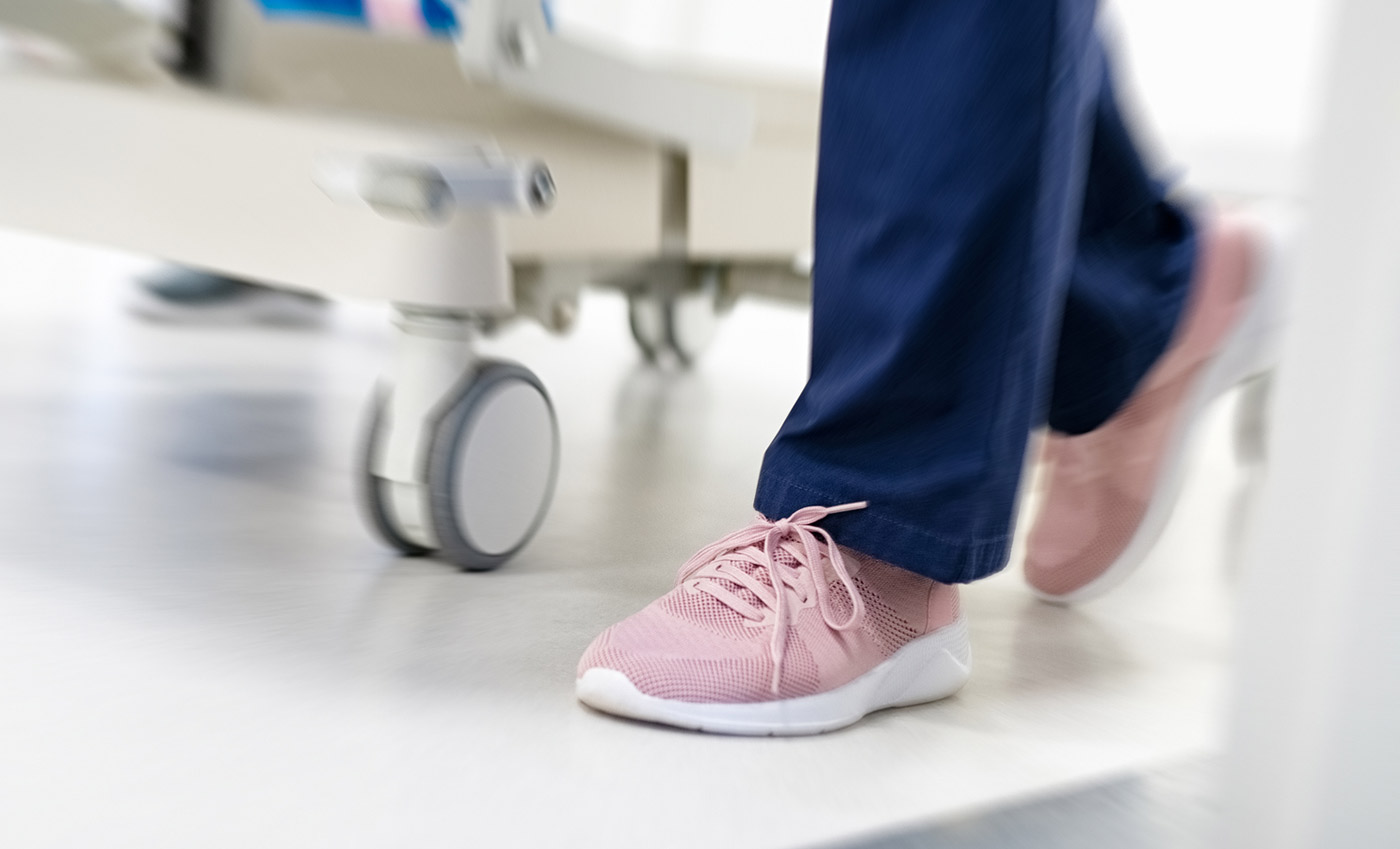 Nurse's feet walking with patient