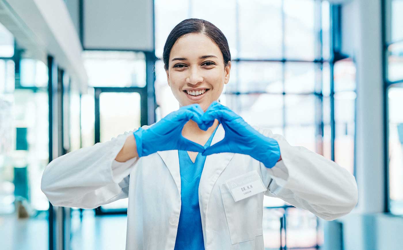 Happy doctor gesturing with heart sign