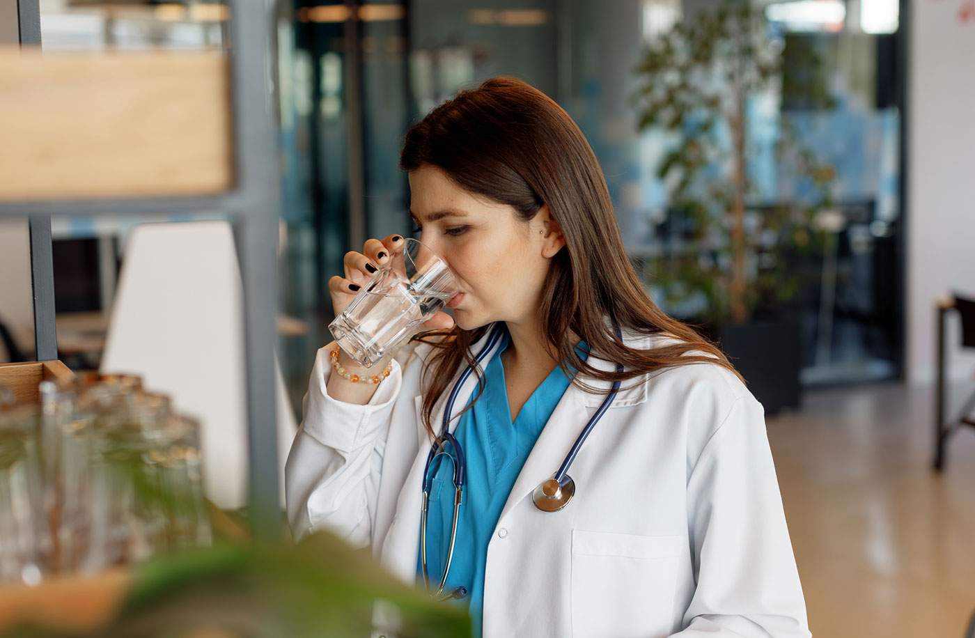 Doctor drinking water staying hydrated